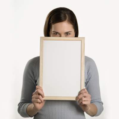 Woman holding dry erase board in front of her