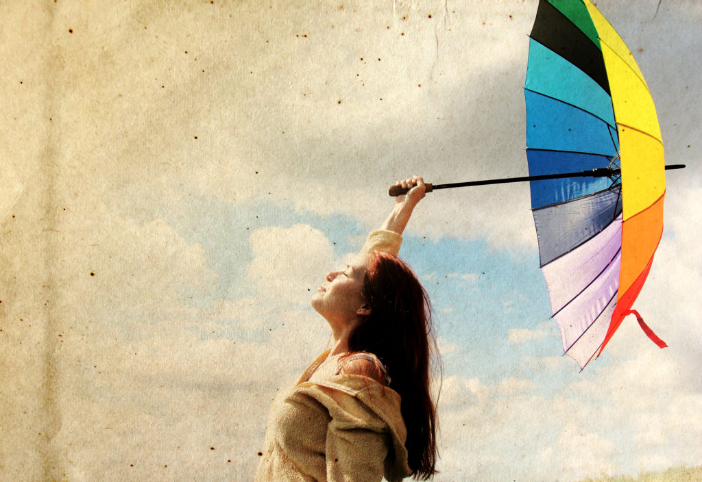 Woman with umbrella. Photo in old color image style.