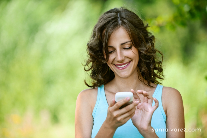 Woman reads message to mobile phone